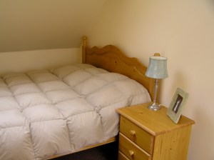 Bed and end table south bedroom